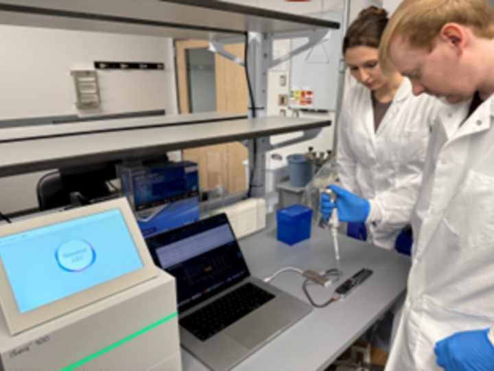 Two members of the molecular diagnostic staff use the latest technology to conduct testing.