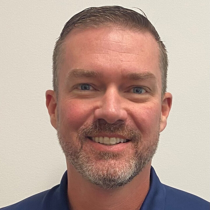 Matt Hille standing in front of a plain background.