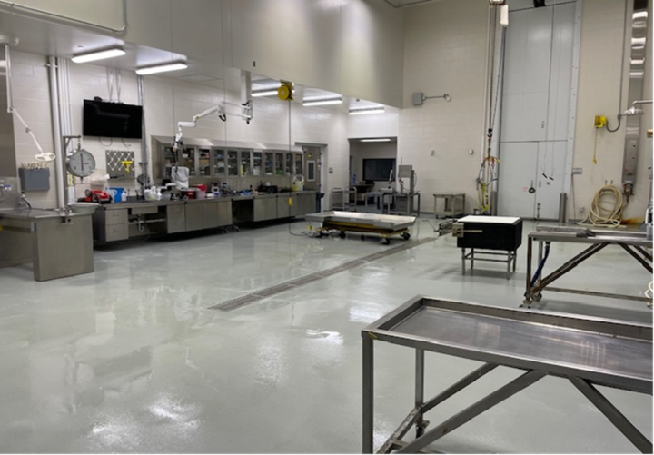 The necropsy lab with stainless steel tables, work station and lab equipment.